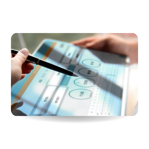 There is a hand with a pen pointing to a tablet where there are numbers and information