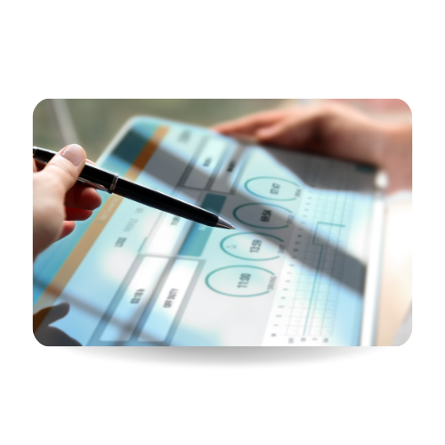 There is a hand with a pen pointing to a tablet where there are numbers and information