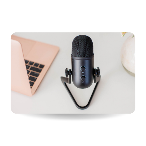 There is a laptop and a professional microphone next to it